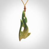 This photo shows a hook pendant carved from New Zealand Flower Jade. The artist, Shaun Gardiner, has carved this beautifully. We provide this piece with an adjustable Kalahari cord. This is a fantastic work of art, we have one only.